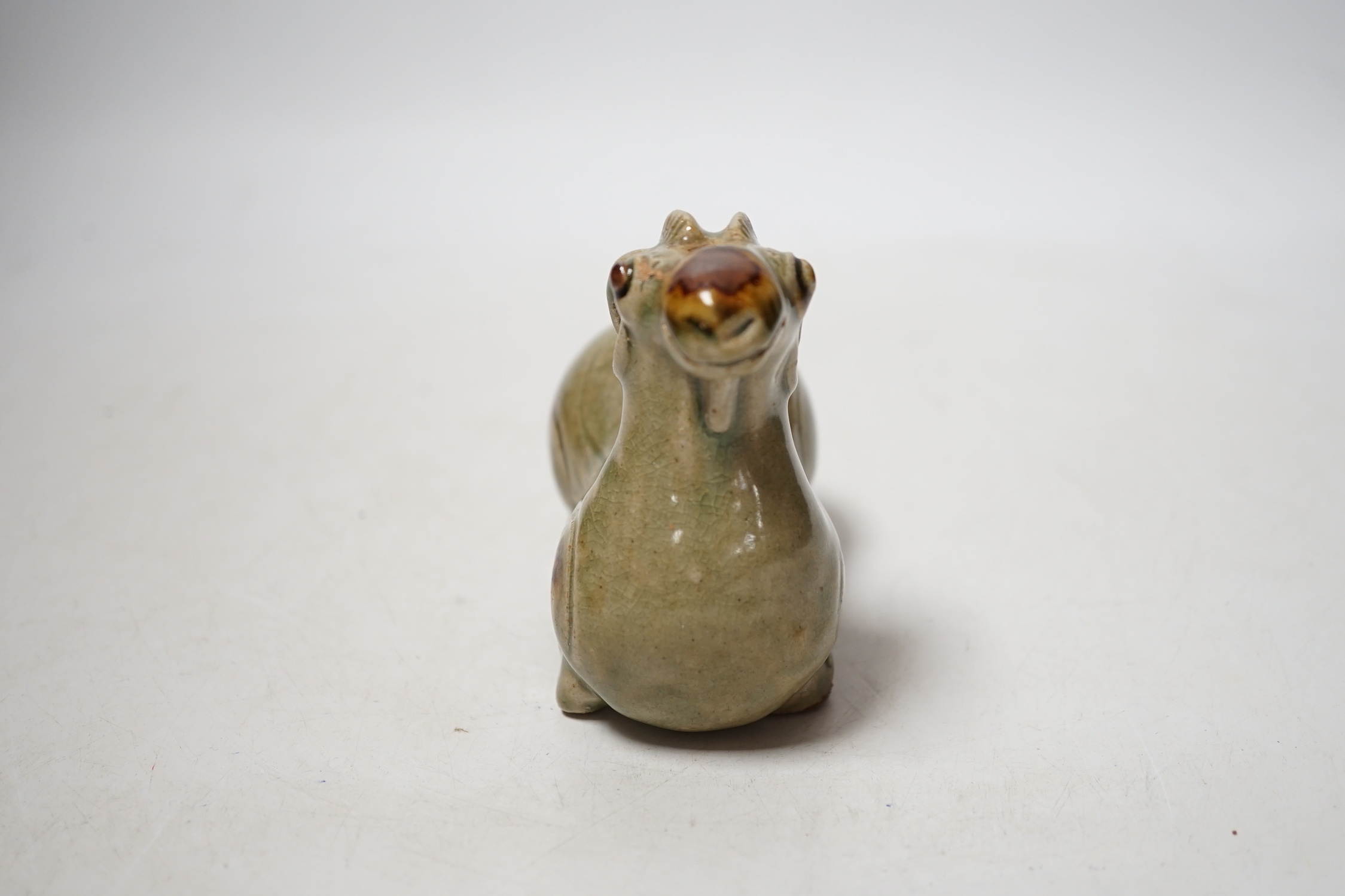 A Chinese Yue type green glazed model of a ram, 10cm wide
